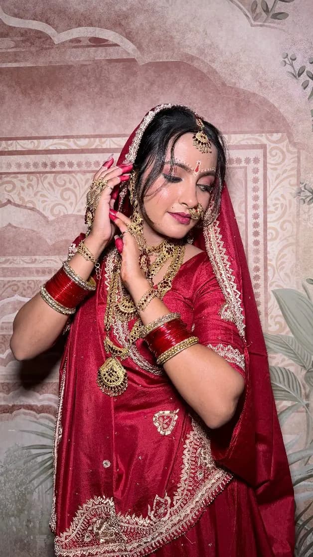 Bride in a red lehenga with chooda and a soft, glowing base