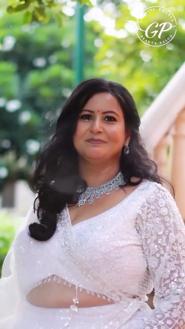 Elegant look for the mother of the bride in a white embellished saree